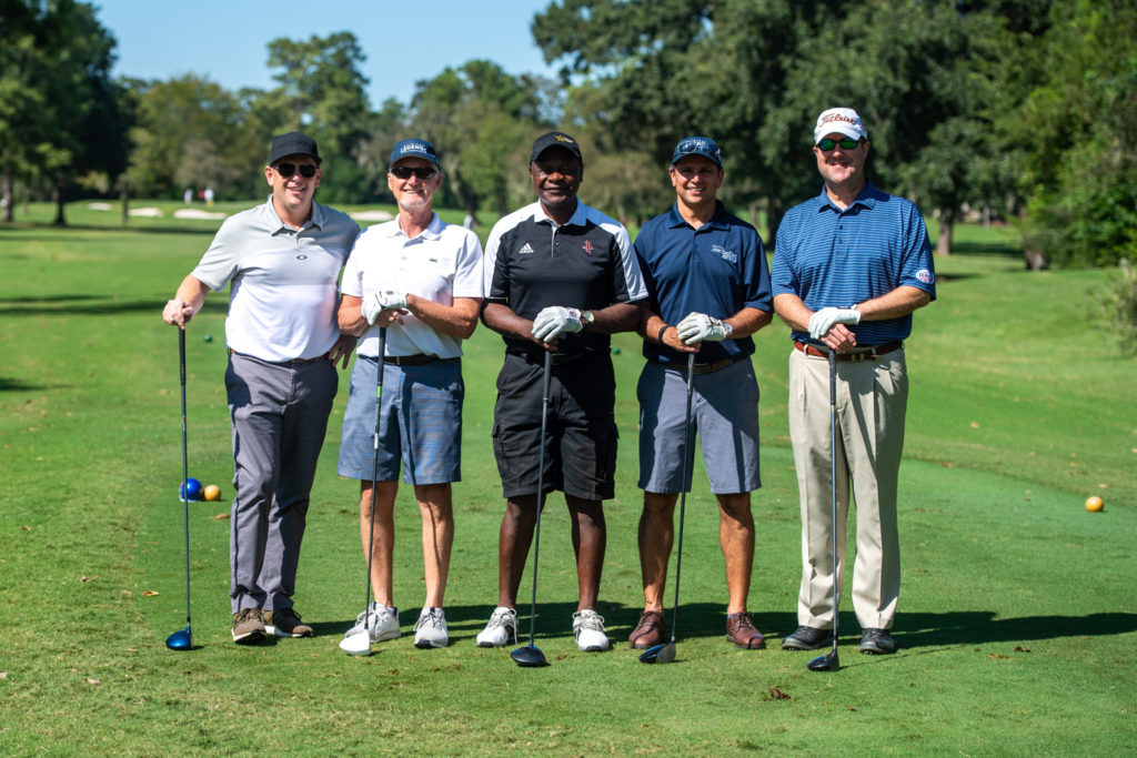 Dr. Korsh Jafarnia plays with golf legend Calvin Murphy in the Gridiron Legends Golf Tournament
